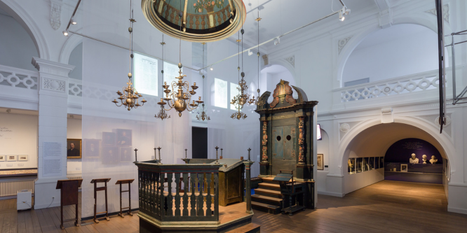 Inneneinrichtung der Hornburger Synagoge aus Holz und Gold vor einem weißen Hintergrund.